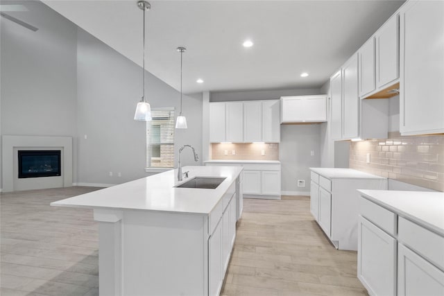 23415 Breckenridge Dale Ln, Spring, TX 77373 - kitchen with a sink, light wood-type flooring, recessed lighting, decorative backsplash, and a center island with sink