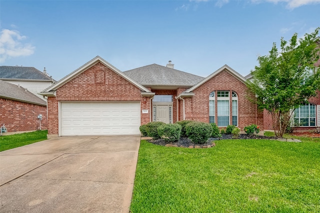 view of front of house featuring a garage and a front lawn