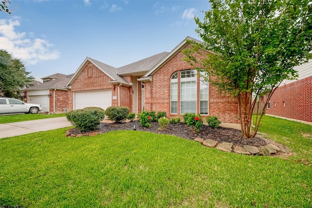 view of front of property with a garage and a front lawn