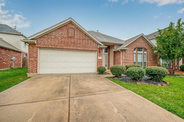 view of front of house featuring a garage and a front lawn