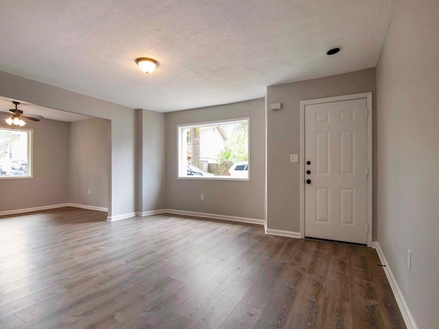 entrance foyer featuring a textured ceiling, ceiling fan, and hardwood / wood-style flooring