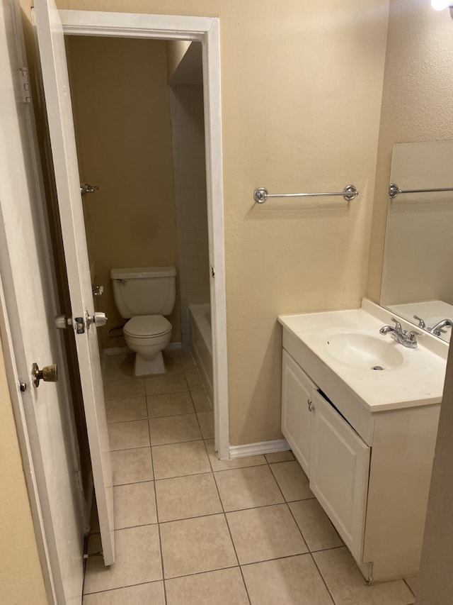 bathroom with tile patterned flooring, toilet, and vanity