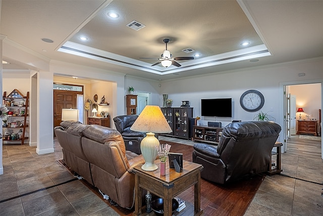 living room with crown molding, a raised ceiling, and ceiling fan