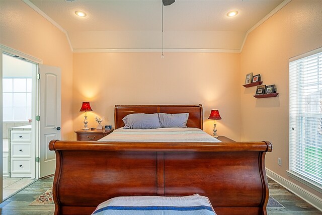 bedroom with vaulted ceiling, ornamental molding, and light wood-type flooring