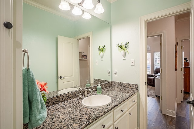 bathroom featuring crown molding, vanity, and hardwood / wood-style flooring