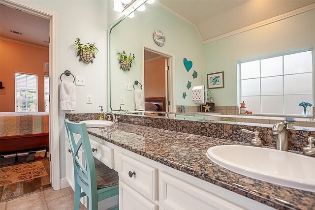 bathroom featuring tile patterned flooring, crown molding, and vanity