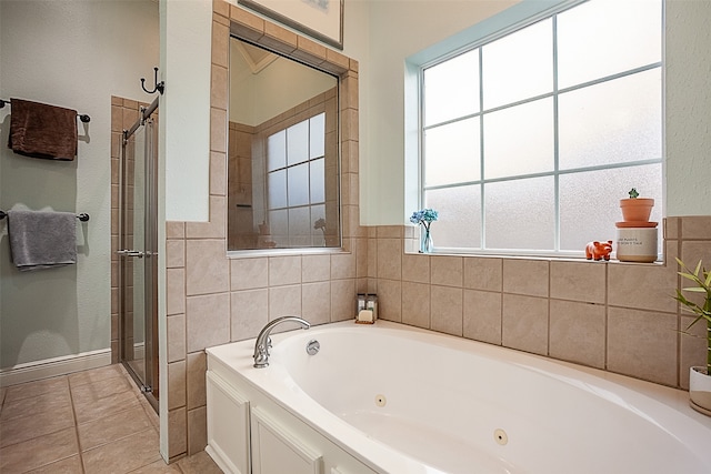 bathroom with shower with separate bathtub and tile patterned floors