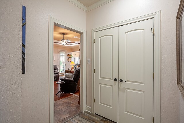 corridor featuring dark wood-type flooring and ornamental molding