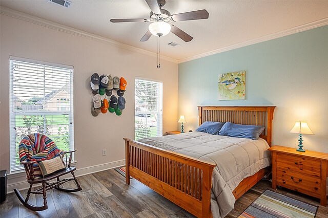 bedroom featuring ceiling fan, dark hardwood / wood-style flooring, and crown molding