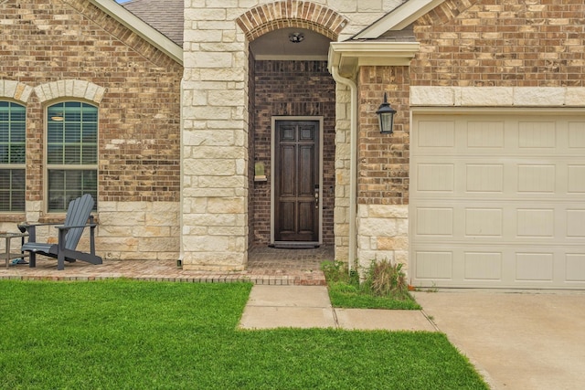 doorway to property with a lawn and a garage