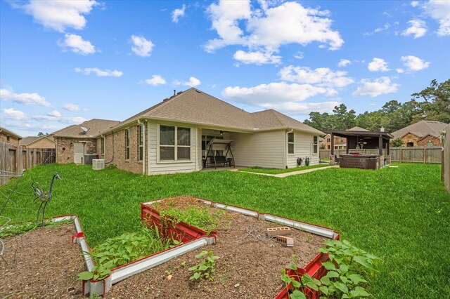 rear view of property with a yard, central AC, and a patio