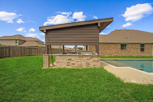 view of yard featuring area for grilling and a fenced in pool