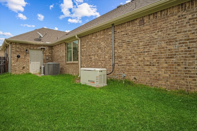 exterior space featuring central AC unit and a lawn