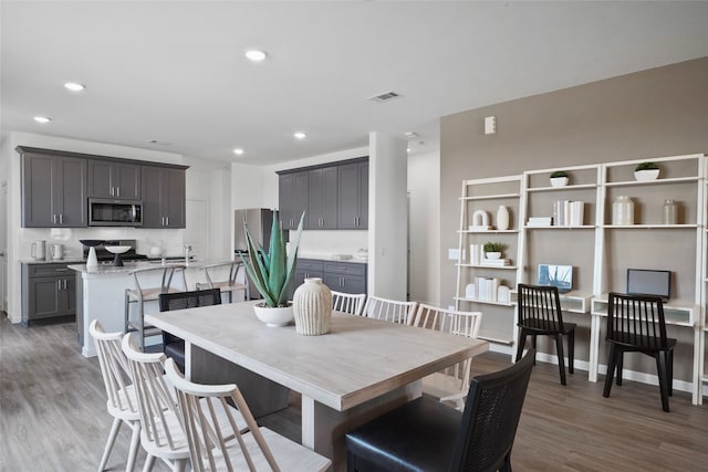 dining area with hardwood / wood-style flooring