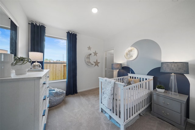 bedroom with light colored carpet and a crib