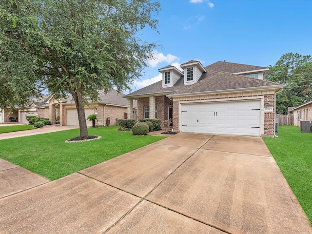 view of front of home featuring central AC, a garage, and a front lawn