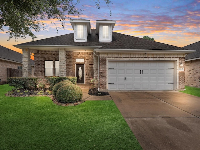 view of front facade with a garage and a lawn