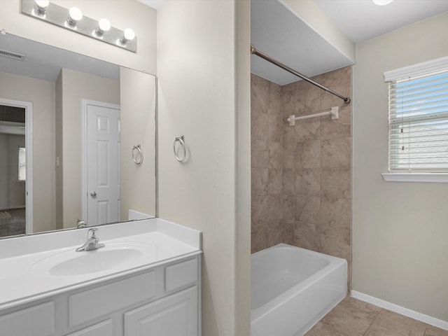 bathroom featuring vanity, tiled shower / bath combo, and tile patterned floors