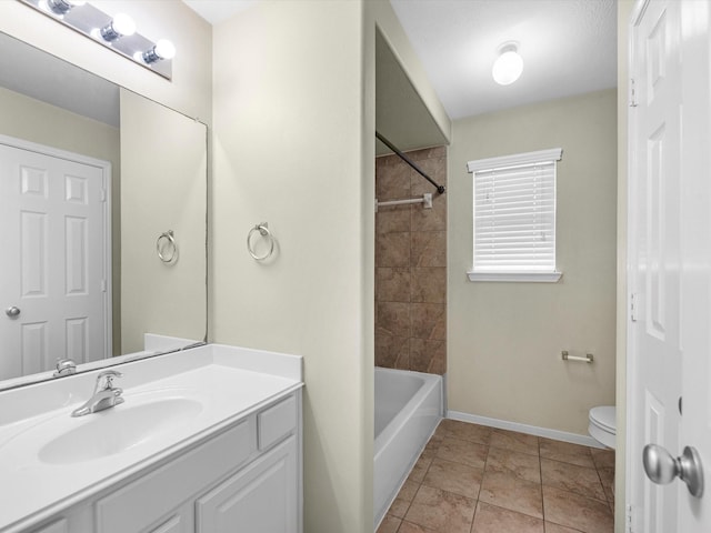 full bathroom featuring tile patterned flooring, vanity, toilet, and tiled shower / bath