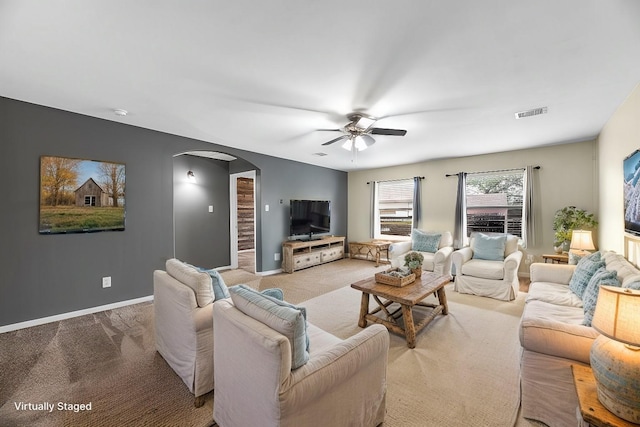 carpeted living room featuring ceiling fan