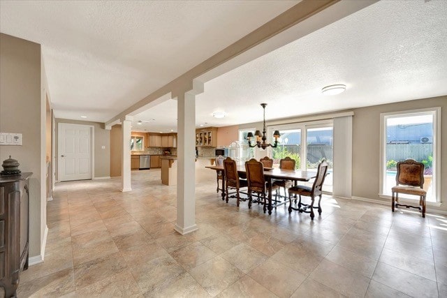 dining space featuring a textured ceiling and an inviting chandelier