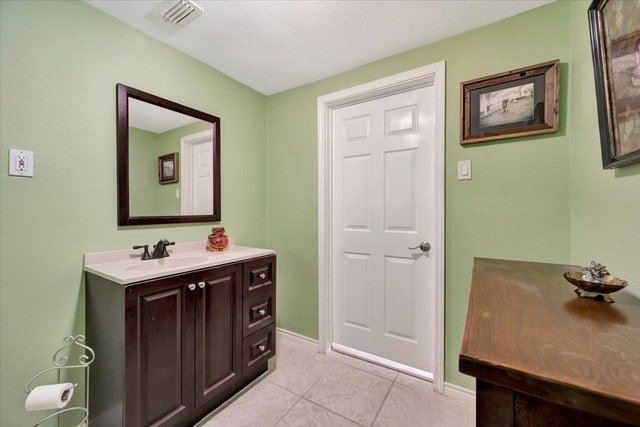 bathroom featuring tile patterned flooring and vanity