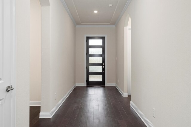 doorway with ornamental molding and dark wood-type flooring