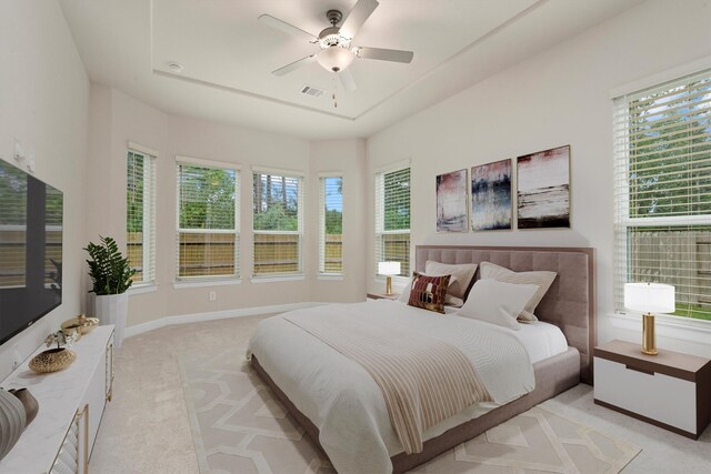 carpeted bedroom with multiple windows and ceiling fan