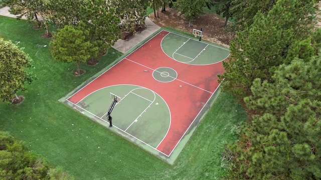 view of sport court featuring a lawn