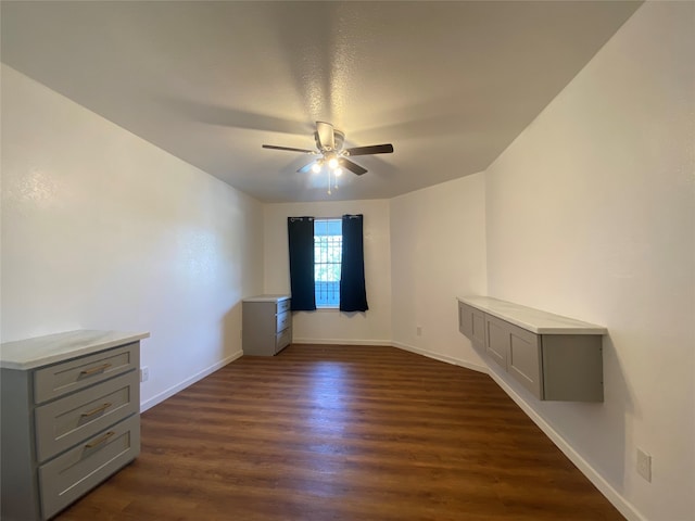 unfurnished room featuring dark hardwood / wood-style flooring and ceiling fan