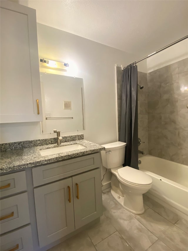 full bathroom featuring shower / bath combo, toilet, and vanity