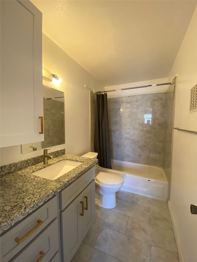 full bathroom with tile patterned flooring, toilet, shower / tub combo, vanity, and a textured ceiling