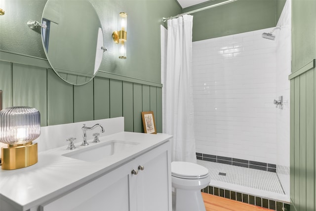 bathroom with wood-type flooring, toilet, vanity, and curtained shower