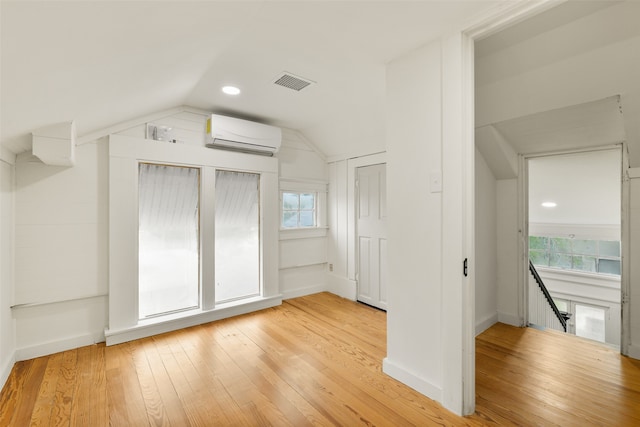 additional living space featuring lofted ceiling, light hardwood / wood-style flooring, and a wealth of natural light