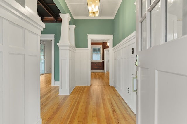 interior space with light hardwood / wood-style floors, ornamental molding, and plenty of natural light