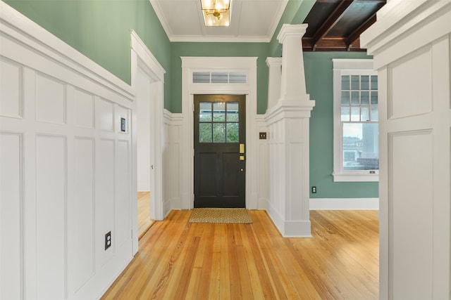 entryway featuring light wood-type flooring and ornamental molding