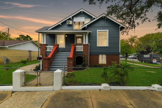 view of front of property featuring a lawn and a porch