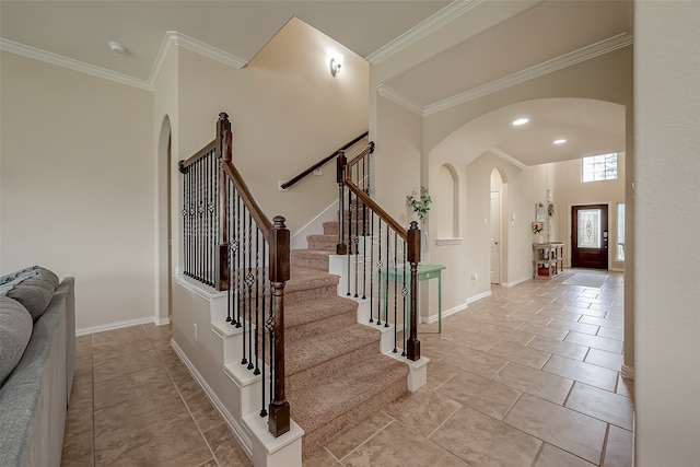 entrance foyer featuring light tile patterned floors and ornamental molding