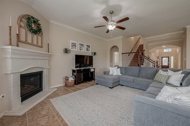 tiled living room with ceiling fan and ornamental molding