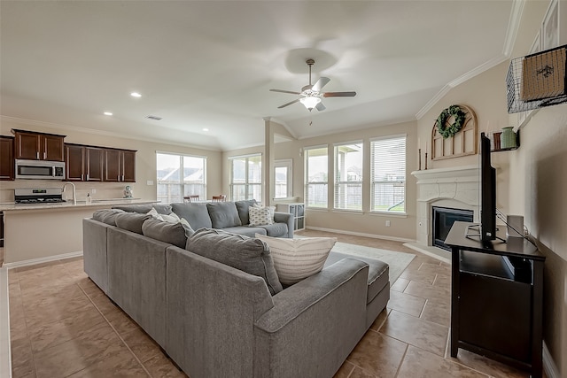 tiled living room with ceiling fan, crown molding, and vaulted ceiling