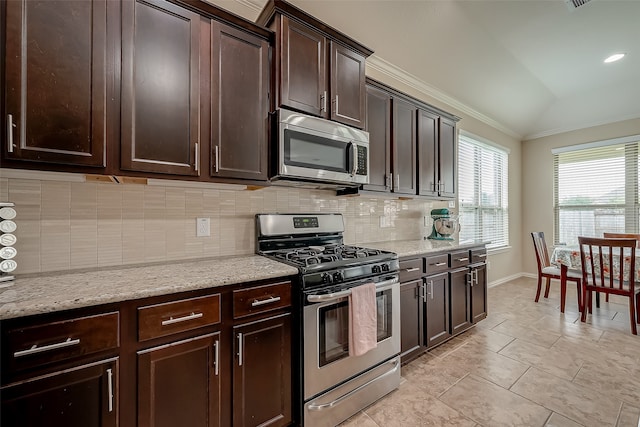 kitchen with dark brown cabinetry, backsplash, lofted ceiling, appliances with stainless steel finishes, and ornamental molding