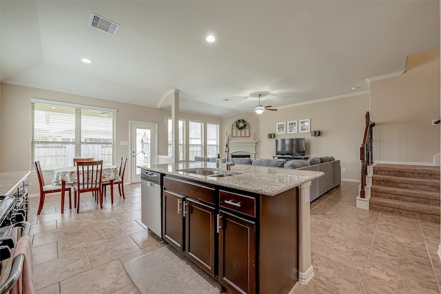 kitchen featuring a kitchen island with sink, plenty of natural light, stainless steel appliances, and dark brown cabinets