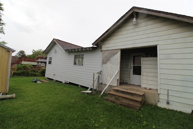 rear view of property featuring a yard