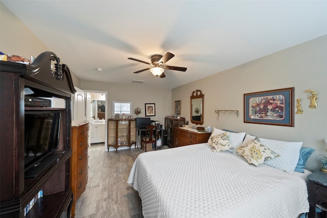 bedroom with connected bathroom, ceiling fan, and light hardwood / wood-style floors