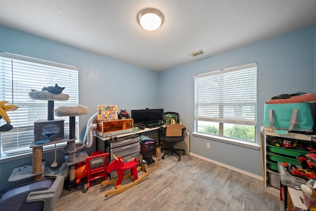 office area with hardwood / wood-style flooring and a textured ceiling