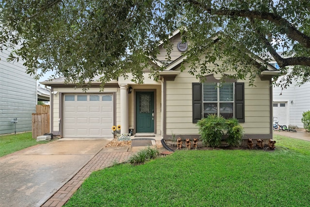 view of front of home with a garage and a front lawn