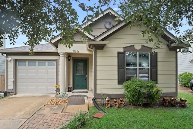 view of front of house with a garage and a front yard