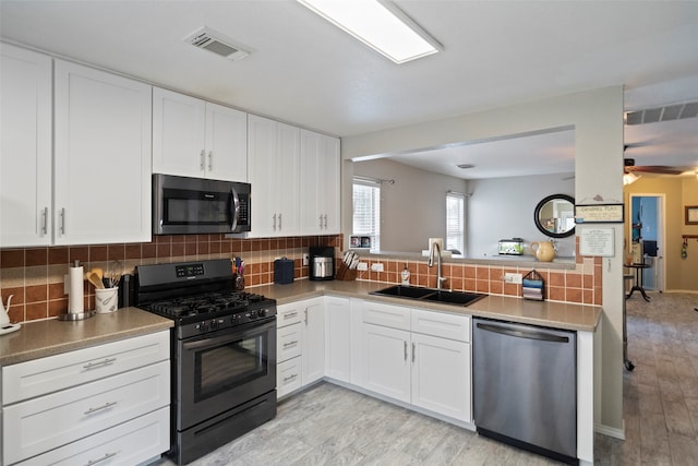 kitchen featuring light hardwood / wood-style flooring, stainless steel appliances, sink, and white cabinetry