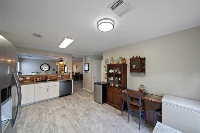 kitchen with dishwashing machine, ceiling fan, stainless steel fridge with ice dispenser, white cabinets, and light hardwood / wood-style floors