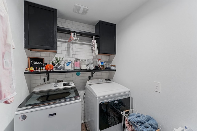 washroom with cabinets and independent washer and dryer